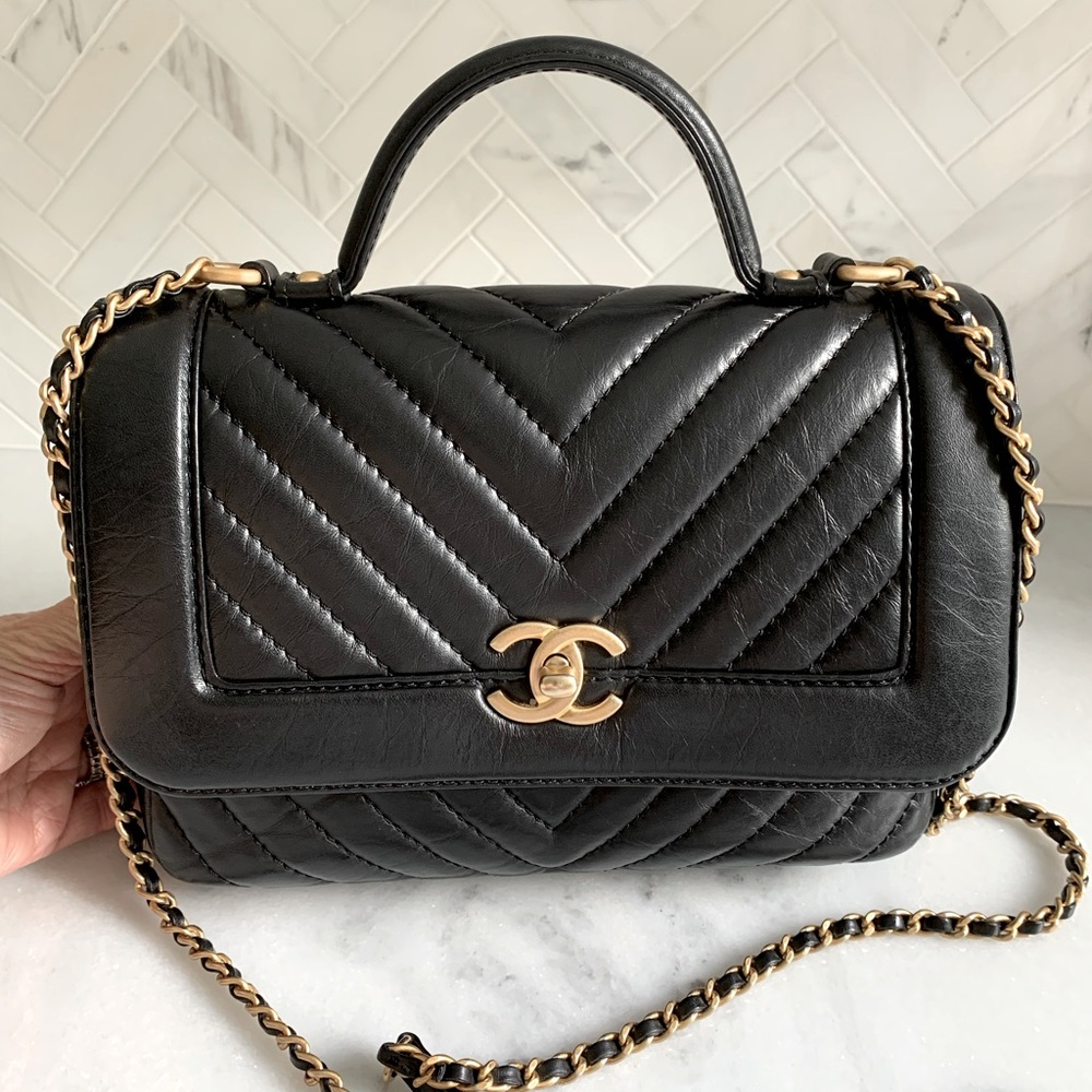 Chanel top handle black chevron distressed leather with gold hardware.
